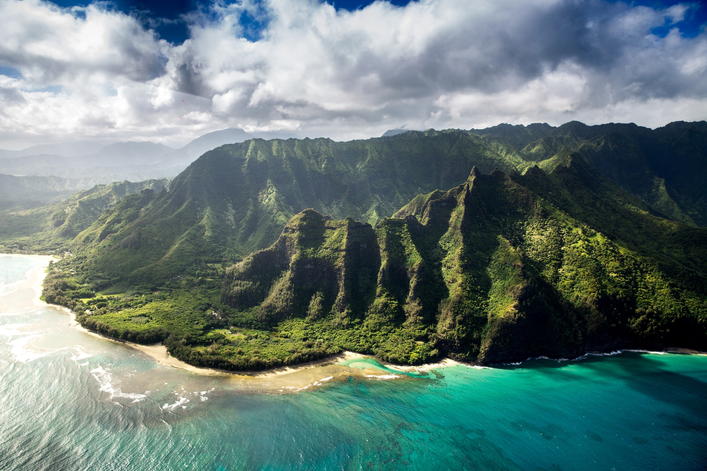 aerial photo of green mountain with ocean