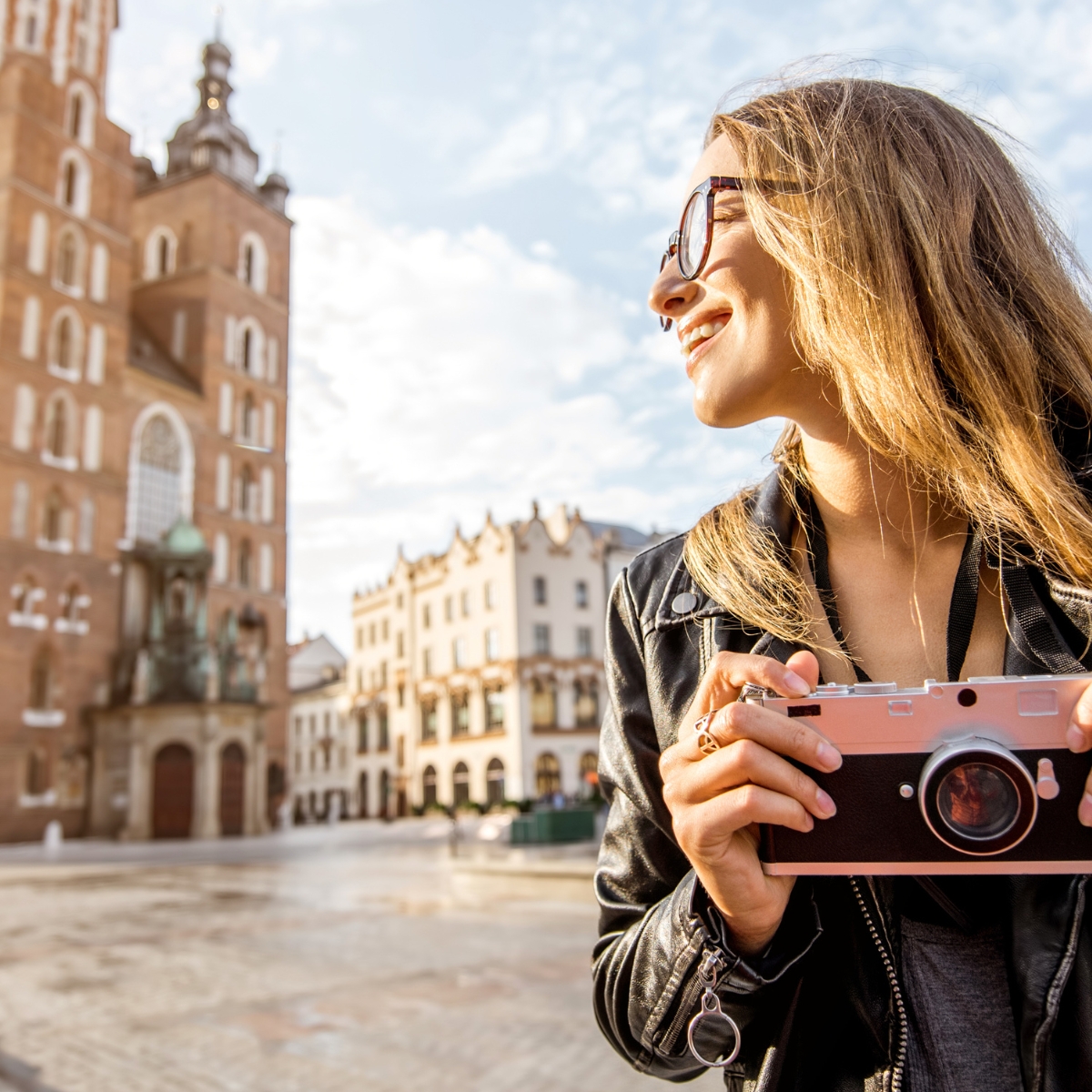 woman enjoying sights with camera on vacation for the post Why use a travel agent 12 practical reasons